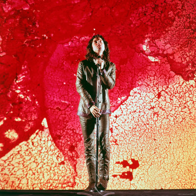 Rock Singer Jim Morrison of the Doors Posing in Front of Red and Yellow Psychedelic Backdrop